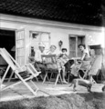 Frederik (in a Newspaper Hat), Grete, Asta and Cousin Hanne on the Patio